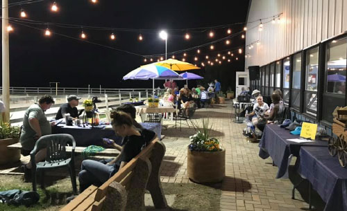 people sitting around the patio at night