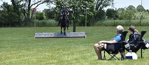 jump judges viewing rider over jump on course